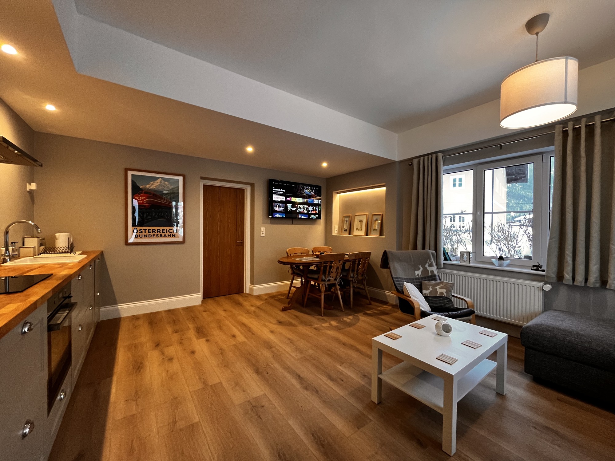 Open-plan apartment with kitchen, dining table and sofas